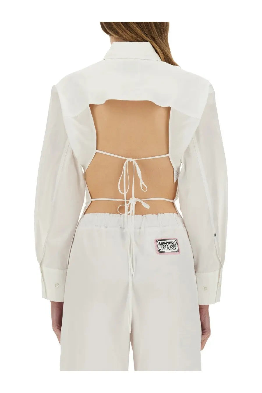 Back view of moschino jeans women’s white cotton cropped button-up shirt with cutout and tie details