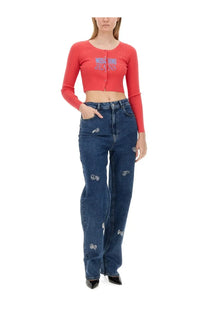 High-waisted blue denim jeans with silver heart-shaped embellishments along the legs from moschino jeans women’s cropped cardigan white collection