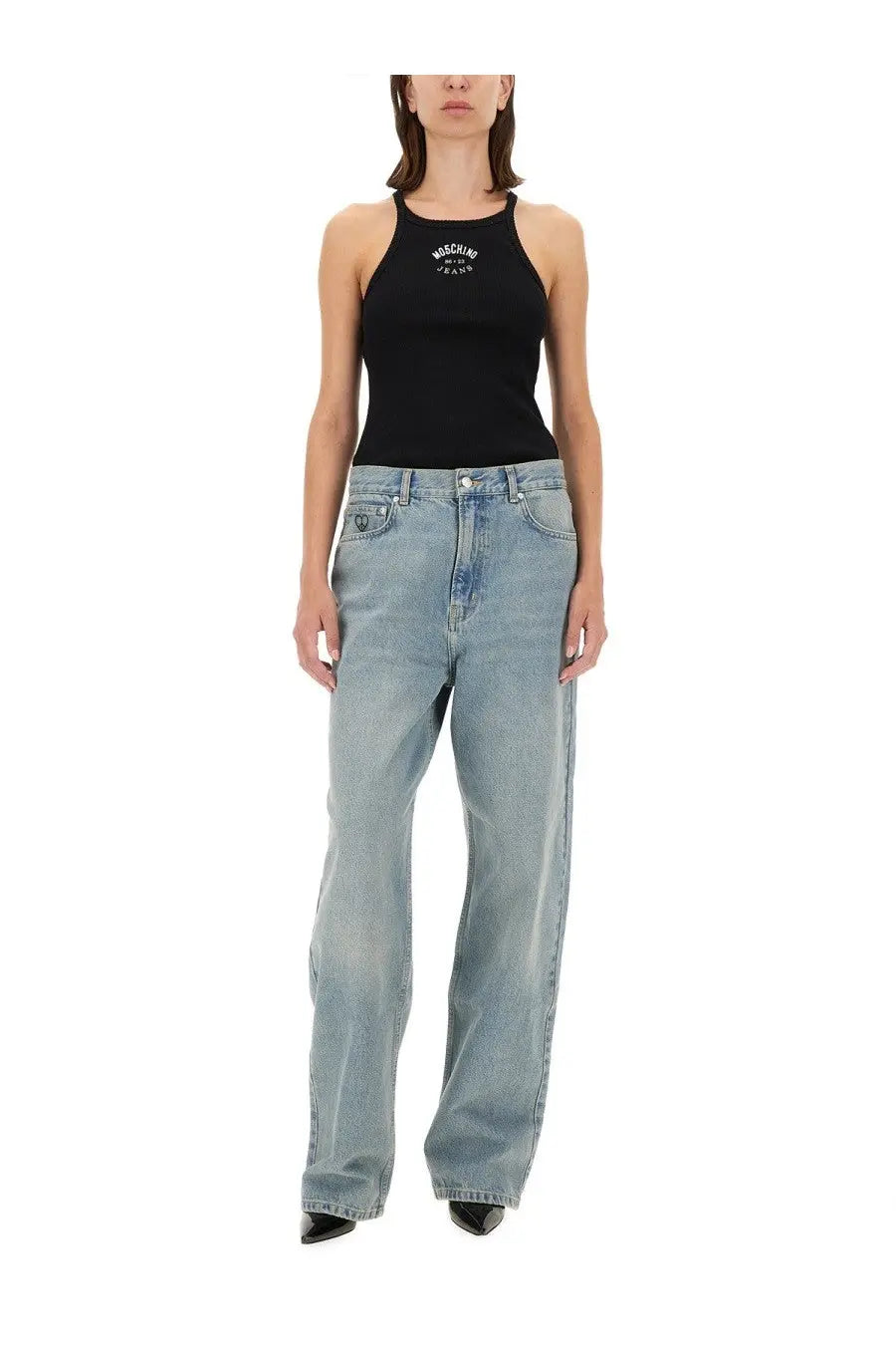 Black Moschino tank top with white logo embroidery paired with blue Moschino Jeans women’s denim pants