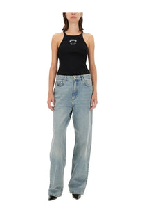 Black Moschino tank top with white logo embroidery paired with blue Moschino Jeans women’s denim pants