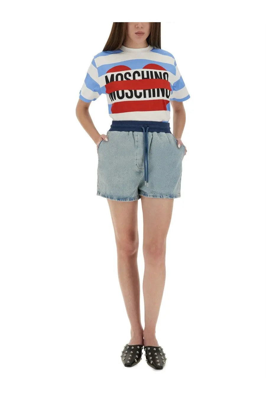 Moschino jeans women’s denim shorts in blue paired with a blue and white striped t-shirt featuring a red heart logo
