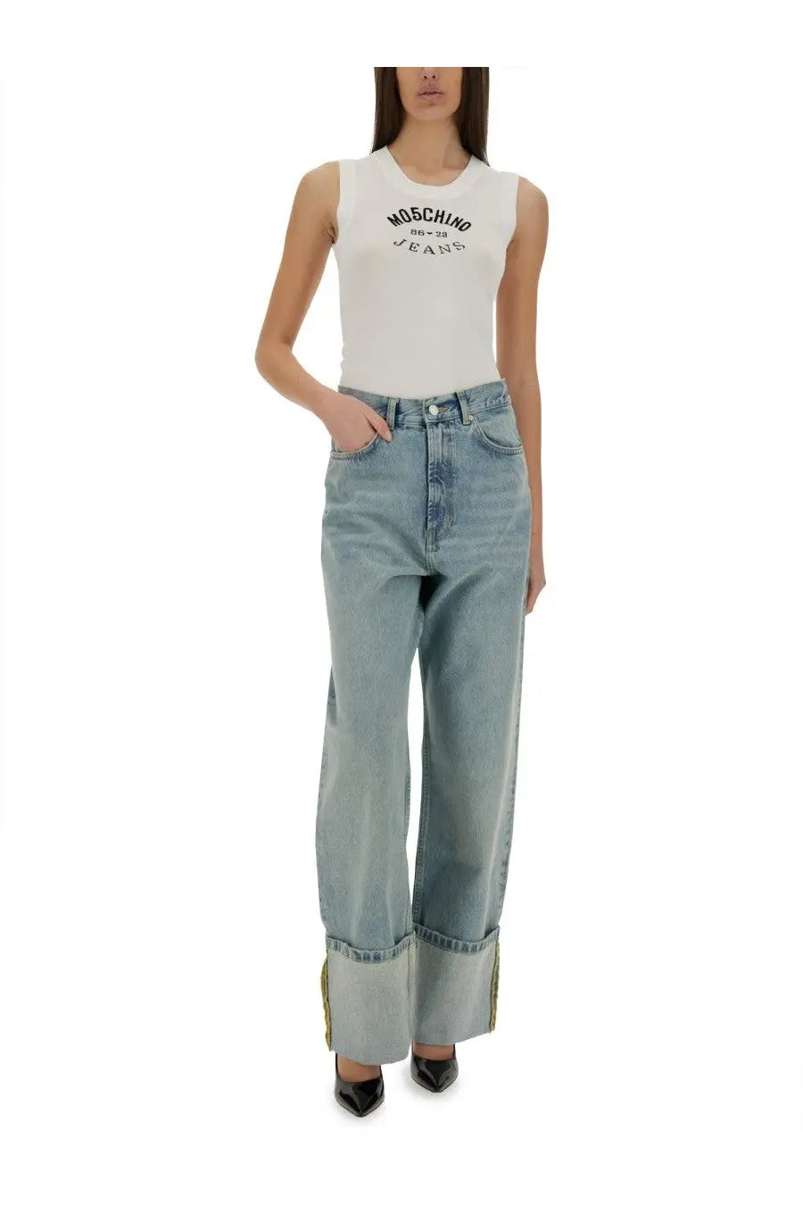 High-waisted light blue denim jeans with rolled cuffs and subtle gold trim styled with Moschino white knit top