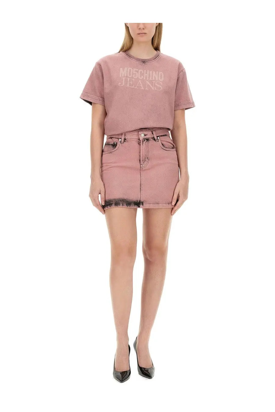 Pink Moschino jeans cropped t-shirt with faded lettering and rolled sleeves paired with blue mini skirt front view
