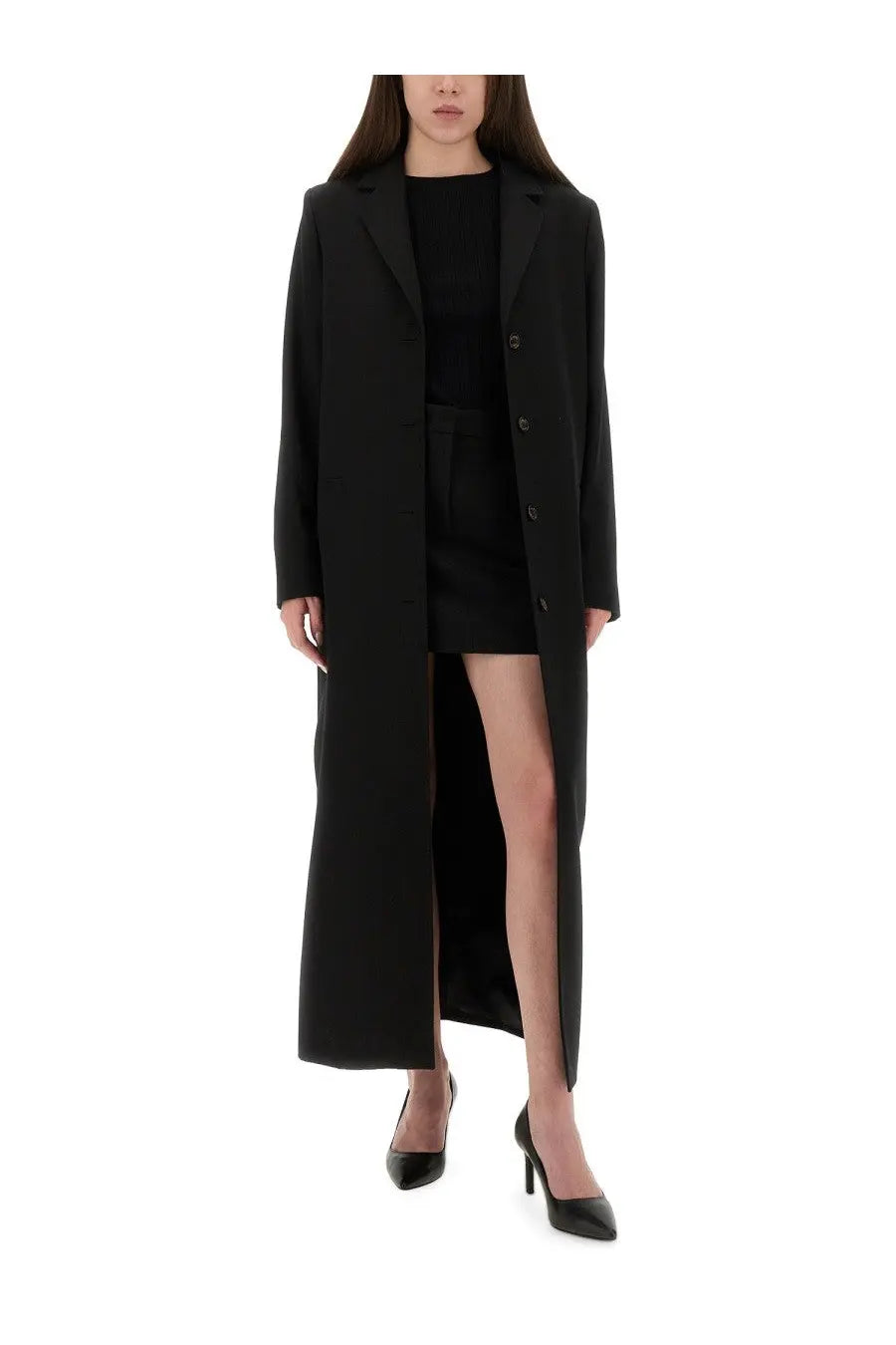 Black long coat with front slit and button closure paired with moschino jeans women’s mini tailored skirt black