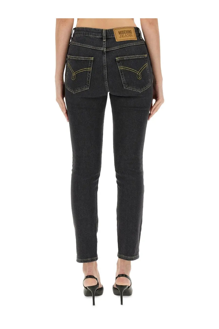 Moschino women’s black denim skinny fit jeans with yellow stitching and brown leather patch at waistband back side