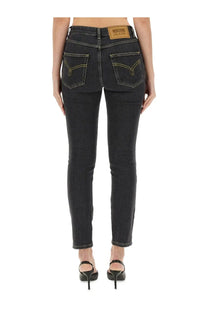 Moschino women’s black denim skinny fit jeans with yellow stitching and brown leather patch at waistband back side