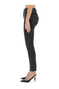 Back side of black Moschino skinny fit jeans with subtle faded wash and yellow stitching on the back pocket