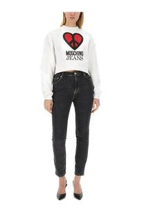 White moschino jeans sweatshirt with bold red heart peace symbol graphic and black lettering front design
