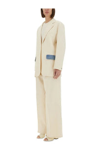 Cream-colored Moschino Jeans women’s wool-blend blazer with a distinctive blue denim patch on the left side seam