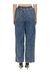 Back side of moschino women’s blue denim wide leg jeans with elastic waistband and subtle logo on back pockets
