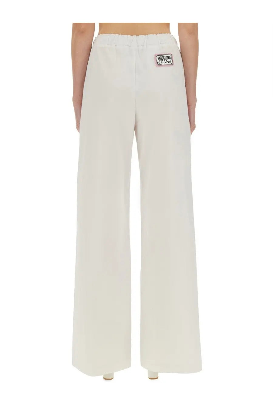 Back view of cream-colored moschino jeans wide leg pants with drawstring waistband and brand patch on the pocket