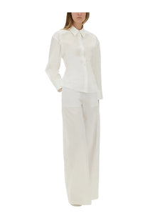 A crisp white button-down shirt with long sleeves paired with Moschino Jeans women’s wide leg pants white