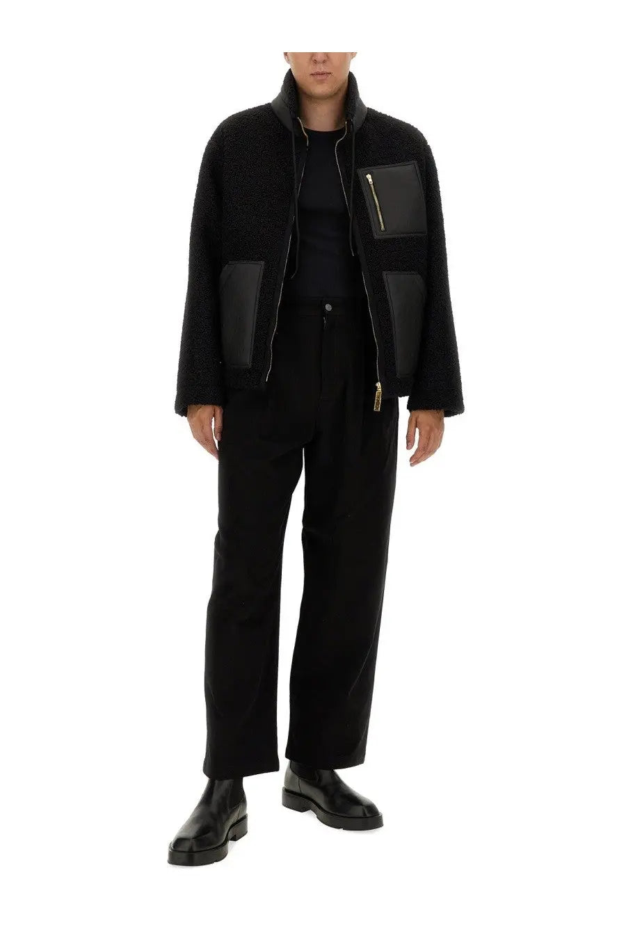 Black shearling jacket with black leather patch pockets and gold-tone zippers paired with moschino men’s barcode pant black