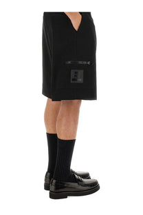 Moschino men’s bermuda black shorts with zipper pocket and branded patch featuring a sleek modern design