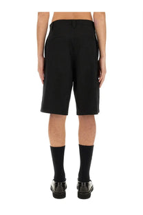 Moschino men’s Bermuda black tailored shorts with sleek modern cut and subtle pleats at the back shown from the back side