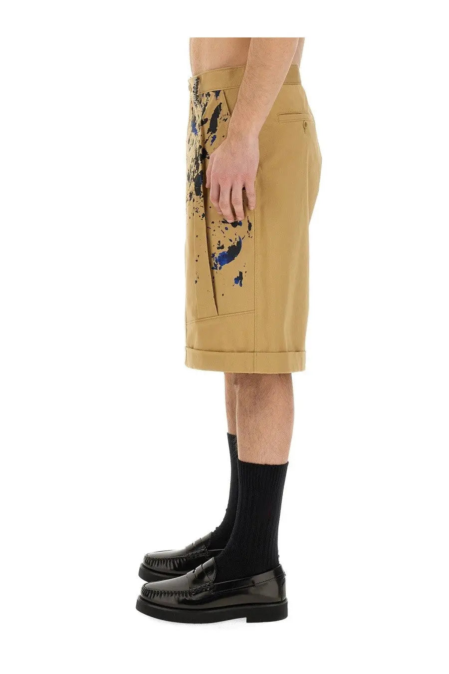 Moschino men’s bermuda cargo beige shorts in structured fabric with bold blue paint-splatter design on tan base
