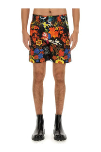 Moschino men’s bermuda shorts with vibrant red orange blue and yellow floral pattern on black background