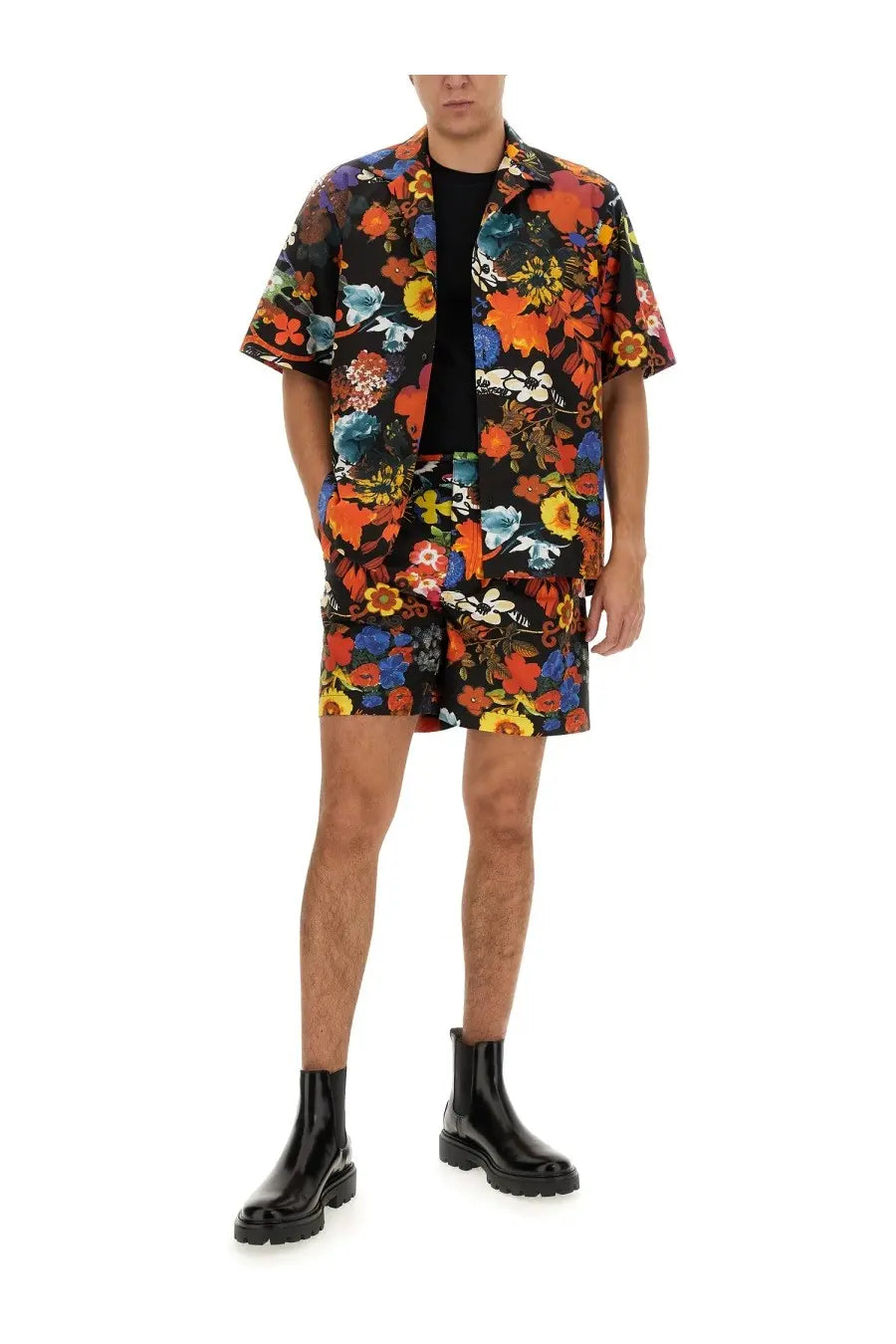Moschino men’s Bermuda multicolor vibrant floral print short-sleeved shirt and matching shorts set on black background