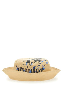 Beige moschino men’s bucket hat with black and blue paint splatter design for casual wear