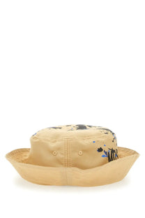 Moschino men’s beige canvas bucket hat with black and blue paint splatter design