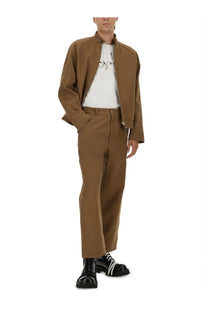 Moschino men’s brown cotton bomber jacket with stand-up collar and front zipper worn over white graphic tee