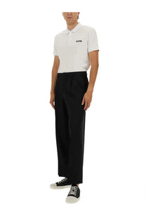 Moschino men’s white cotton pique polo shirt with black embroidered logo on the chest