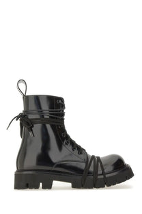 Moschino men’s black patent leather combat boot with crisscross lacing and chunky sole front view