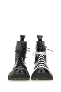 Moschino men’s black patent leather combat boots with white laces and chunky rubber sole