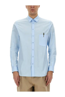 Light blue moschino men’s office inspiration long-sleeved button-down shirt with chest pocket holding a pen