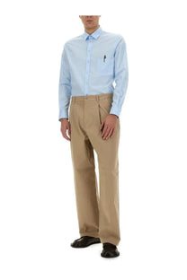 Moschino men’s light blue long-sleeved button-down shirt with chest pocket and pen for office inspiration