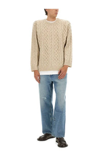 Moschino men’s beige cable knit pullover sweater with intricate pattern and ribbed cuffs in soft material