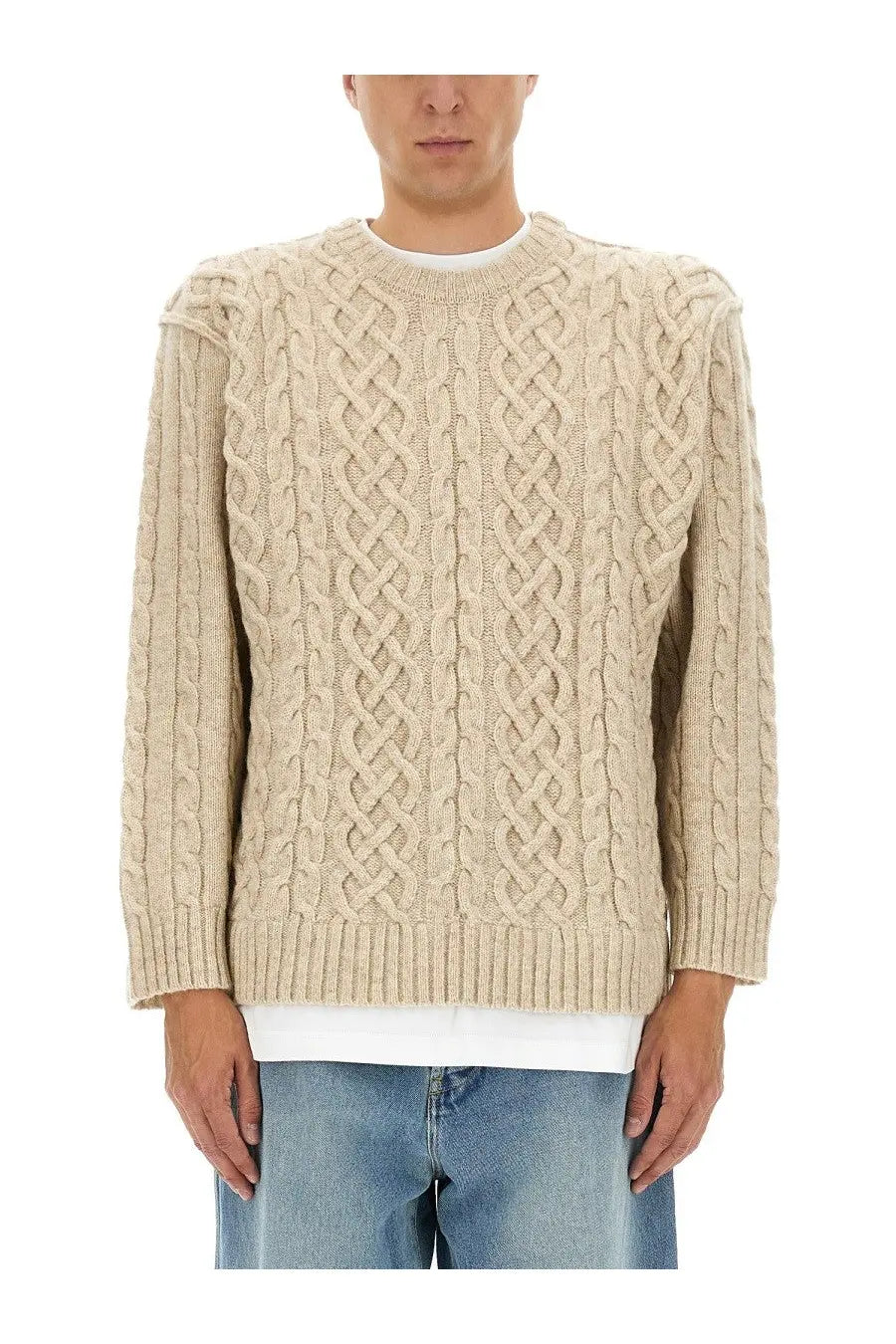 Moschino men’s beige cable knit pullover sweater with intricate braided pattern and ribbed cuffs