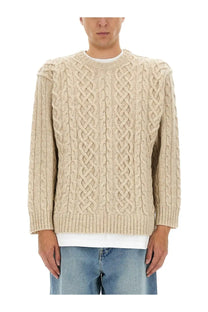 Moschino men’s beige cable knit pullover sweater with intricate braided pattern and ribbed cuffs