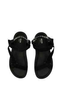 Moschino men’s sandal black with sleek minimalist design and bold white branded straps in black leather material
