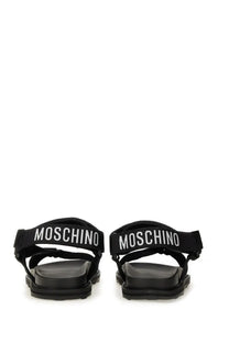 Moschino men’s sandal black featuring black sandals with white logo straps and chunky rubber sole