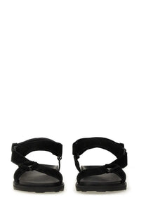 Moschino men’s black suede sandals with minimalist design and adjustable straps shown from the back side