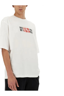 Moschino men’s white cotton t-shirt with bold two-tone graphic print dress as you wish not as you should across chest
