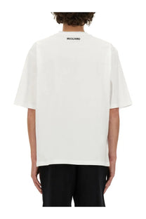 Moschino men’s white oversized t-shirt with black logo at the neckline made from soft cotton fabric