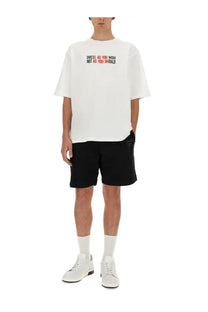 Moschino men’s white oversized t-shirt with dress as you wish not as you should print in red and black across chest