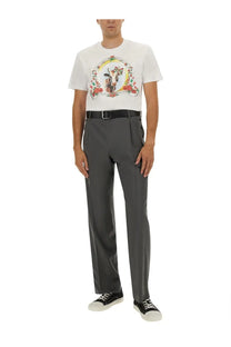 Moschino men’s white t-shirt featuring a colorful ornate circular graphic with floral elements and an animal figure
