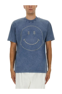 Moschino men’s blue heavy cotton t-shirt with a smiley face design outlined in silver studs resembling denim