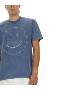 Moschino men’s blue heavy cotton t-shirt with a denim look featuring a silver stud outlined smiling face design