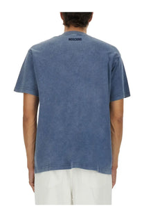 Blue washed cotton t shirt with moschino logo printed in black at the neckline from moschino men’s smiley heavy cotton shirt blue