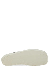 White rubber sole with subtle texture on moschino men’s sneaker edge black for casual wear