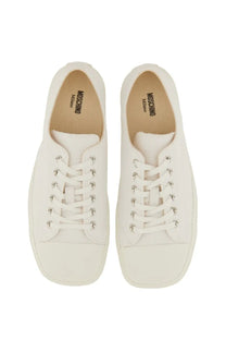 Moschino men’s sneaker edge white canvas low-top with silver eyelets and minimalist design featuring logo insole