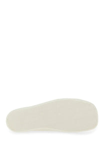 Cream-colored rubber sole with smooth textured surface and rounded edges on moschino men’s sneaker edge white