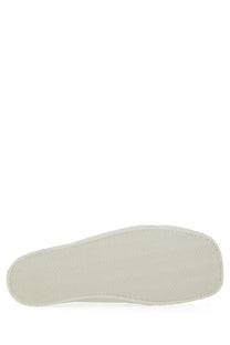 Off-white rubber sole with textured pattern and stitched edges of moschino men’s sneaker edge white
