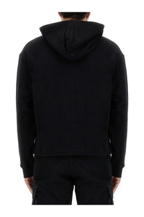 Moschino men’s black hooded sweatshirt with minimalist design and ribbed cuffs in soft cotton material