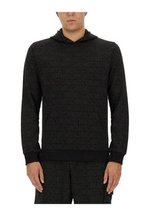 Black moschino men’s sweatshirt hoodie with all-over raised textured moschino logo print pattern