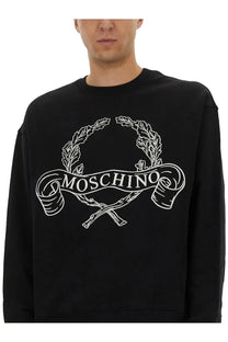 Moschino men’s sweatshirt in black featuring a white embroidered logo with laurel wreaths and crossed sticks